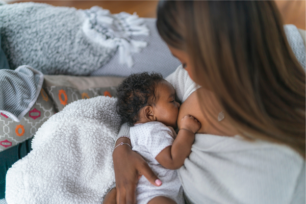 Above shot of a Black mom breastfeeding her baby